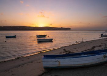 Foz do Arelho, Portugal - November 26, 2018 : Fishing boats on a river sea at sunset in Foz do Arelho, Portugal